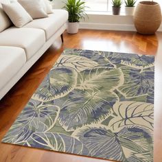 a living room with a white couch and large rug