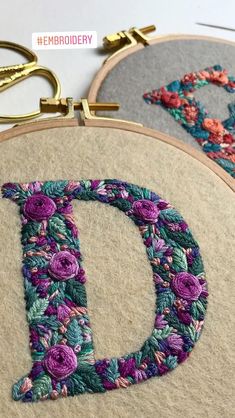 two embroidery hoops with the letter d on them, one is made from flowers