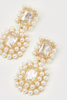 The Lulus Glamorous Ambitions White Pearl Rhinestone Statement Earrings will be the reason why everyone's eyes are on you! These statement-making earrings start with clear, rectangular rhinestones that are framed with slender gold chains and glowing faux pearl details, all connected by jump rings that create a drop-style silhouette. Post backs. 2. 25" Long And 1" Wide. 80% Glass, 20% Plated Brass. Imported. Lulus | Glamorous Ambitions White Pearl Rhinestone Statement Earrings. Glamorous Pearl Crystal Earrings For Party, Sparkling Cubic Zirconia Pearl Earrings For Party, Party Sparkling Cubic Zirconia Pearl Earrings, Gold Rectangular Crystal Earrings For Party, Party Crystal Pearl Earrings With Sparkling Stones, Pearl Jeweled Earrings For Party, Glamorous Gold Rectangular Jewelry, Rectangular Crystal Earrings For Party, Rectangular Crystal Jewelry For Party