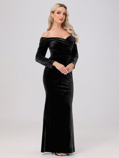 a woman wearing a black velvet gown with long sleeves and an off the shoulder neckline