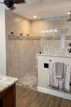 a bathroom with a walk in shower next to a sink and toilet paper dispenser