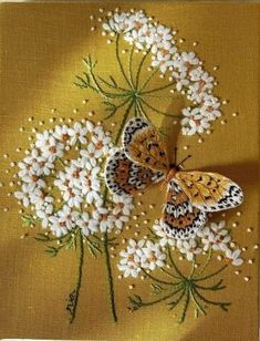 two butterflies sitting on top of white flowers with green stems in the middle and yellow background