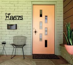 a pink door and chair in front of a white brick wall with the word exit on it