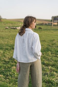 "An Oversized Linen Shirt is for sure a wardrobe staple for all times. Classic modest style is moderately embellished with stylish patch pockets. This white button up shirt can be favorably combined both with loose and classic bottoms. A slightly cropped design delicately hints at the waistline. Thus, it creates a perfect balance to a current-day trend on oversized clothes. DETAILS ⚬ Spread collar. ⚬ Patch pockets are decorated with handmade fancy stitches. ⚬ Button fastening. ⚬ 3/4 sleeve. ⚬ Sl White Collared Shirt For Fall, White Relaxed Fit Blouse With Collared Neckline, Relaxed Fit Blouse With Button Cuffs For Casual Gatherings, White Relaxed Fit Blouse With Placket, Everyday Shirt With Button Closure And Collared Neckline, White Relaxed Fit Top With Buttoned Pockets, Everyday Shirt With Collared Neckline And Button Closure, White Collared Shirt With Rolled Sleeves, White Tops With Pockets For Casual Gatherings