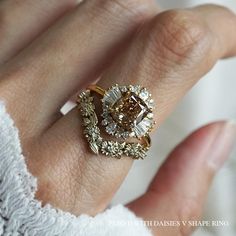 a close up of a person's hand with a ring on top of it