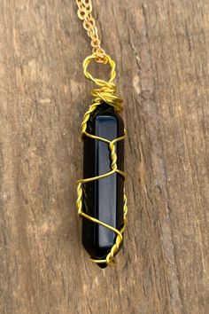 "Beautiful gold wire wrapped Black Agate crystal point pendant on matching chain with lobster claw closure. Other metal colors are available. The pendant is approximately 1.25\" long and 0.4\" wide. Please note that all crystals are unique and therefore color, shape and size may vary slightly. Please choose a necklace length from the drop-down menu. In case you would like a length other than the listed options, leave us a note at checkout. Item will be shipped 2 - 3 business days after purchase. Hand Wrapped Gold Agate Necklaces, Hand Wrapped Gold Agate Necklace, Wire Wrapped Amulet Crystal Pendant Necklace, Wire Wrapped Amulet Pendant Crystal Necklace, Boho Crystal, Quartz Crystal Necklace, Black Agate, Agate Crystal, Necklace Boho