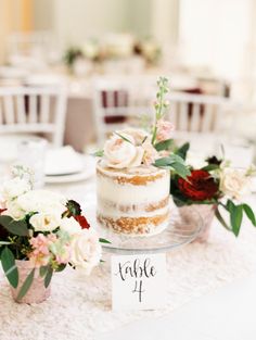 the table is set with white and red flowers