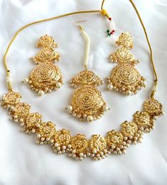 Handcrafted with love to give a real traditional look for this set beautifully studded with jadau stones and pearls give a royal look. Includes: Necklace, Tikka, and Earrings Elegant Chandbali Bridal Sets For Puja, Elegant Bridal Sets For Puja Festivals, Gold Plated Chandbali Temple Jewelry Sets, Gold Plated Kundan Necklace With Meenakari For Puja, Festive Jewelry Sets With Stone Work For Eid, Festive Chandbali Jewelry Sets For Puja, Festive Eid Jewelry Sets With Stone Work, Festive Eid Temple Jewelry Sets, Gold Kundan Pearl Necklace