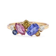 three stone ring in yellow gold with blue, pink and white stones on each side