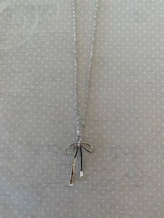 "Sleek and pretty silver tone bow knot necklace.  Simplistic design makes it a versatile piece for any outfit.   Pendant measures 1 1/4\" L X 3/4\" W and is on an 18\" chain.   ★ Want to see more?  Please visit my shop at: https://www.etsy.com/shop/DesignsByPeg" Minimalist Silver Jewelry With Bow, Adjustable Silver Necklace With Ribbon, Silver Adjustable Necklace With Ribbon, Silver Sterling Silver Necklace With Bow, Dainty Silver Necklace With Bow, Adjustable Silver Necklace With Bow, Silver Jewelry With Satin Bow For Gifts, Silver Jewelry With Satin Bow As Gift, Silver Bow Necklace