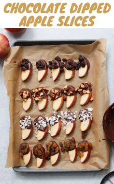 chocolate dipped apple slices on a baking sheet with apples in the background and text overlay