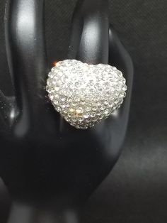 "Awesome vintage find! Bling heart statement ring. One size fits ALL, band is stretchy so you can wear on whichever finger you like. The heart is covered with pave' clear crystals and measures about 1.5\" inches in diameter. It's a great, fun piece that you can dress up or down. Thanks, Enjoy! #ring #jewelry #stunning #statement #fabulous #awesome #amazing #gorgeous #punk #rocker #gothic #victorian #edwardian #infinity #gift #lovely #cosplay #costume #mothersday #birthday #anniversary #hippie #b Trendy Heart-shaped Party Rings, Trendy Party Rings With Heart Shape, Trendy Heart-shaped Rings For Party, Heart-shaped Bling Jewelry For Party, Trendy Party Rings For Valentine's Day, Trendy Rings For Valentine's Day Party, Glamorous Rhinestone Rings Gift, Heart Ring For Valentine's Day Party, Glamorous Rhinestone Rings Perfect For Gifts