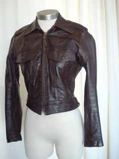 "right out of my incredible vintage closet...it is time for some other petite woman out there to enjoy this outrageous authentic harley davidson chocolate brown jacket..women's size 34 ..excellent vintage condition...obviously well cared for..measures: laying flat, 22\" pit to pit, 23\" shoulder seam to cuff, 15\" shoulder seam measured across the back, 22.5\" long and a 32\" waist..please measure yourself and compare measurements..no returns on sizing..best fits size 2 or 4 women's ..fantastic Fitted Distressed Brown Biker Jacket, Fitted Brown Leather Biker Jacket, Fitted Brown Biker Leather Jacket, Fitted Vintage Brown Leather Winter Jacket, Fitted Vintage Brown Leather Jacket For Winter, Fitted Brown Leather Jacket With Long Sleeves, Brown Fitted Long Sleeve Leather Jacket, Fitted Retro Vintage Brown Outerwear, Vintage Fitted Brown Outerwear