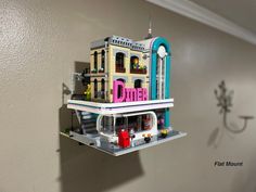 there is a lego model of a building on top of a shelf in the wall