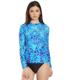 The EQ Swimwear Belize L/S Rash Guard will have you channeling your island flair every time you wear this great piece. With chlorine resistant fabric, this rashguard will last you for years to come in and out of the pool and from the harsh sunlight. Benefits Women’s rash guard. Maximum chlorine resistance reduces fabric breakdown.  Excellent stretch and recovery characteristics retains shape and support.  Low absorbency and quick drying technology enhances your comfort out of the water.  Color-fast technology resists fading.  Durable long sleeve rashguard.  Protects against the cold water.  Unlined: For lighter weight comfort.  Each EQ piece is individually cut and sewn together, not mass produced. Every seam is stitched for maximum durability and performance.  All pieces are designed and Upf 50+ Crew Neck Rash Guard For Summer, Stretch Rash Guard With Upf 50+ And Crew Neck, Stretch Crew Neck Rash Guard With Upf 50+, Fitted Surfing Tops With Upf 50+, Fitted Blue Swimwear With Crew Neck, Upf 50+ Crew Neck Swimwear For Summer, Fitted Blue Crew Neck Swimwear, Printed Rash Guard For Surfing At Beach Season, Printed Rash Guard For Surfing In Beach Season