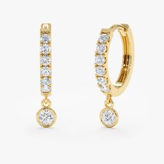 A modern twist on the classic huggie. Elevate your style with our Diamond Drop Hoop Huggie Earrings. Crafted from solid gold, these earrings feature a stunning design with lined natural diamonds, adding a touch of elegance to any ensemble. Perfect for adding a touch of sparkle to your everyday look or for a special occasion, these earrings are a must-have addition to your jewelry collection. - Handmade - Solid Gold - Natural Diamonds - Total Diamond Carat Weight: 0.26 ctw - Diameters: Outer 11 m Huggie Earrings With Lever Back For Wedding, Anniversary Halo Huggie Earrings, Yellow Gold Dangle Huggie Earrings For Anniversary, Diamond Hoop Earrings Small, Diamond Huggies, Beautiful Gift Wrapping, Bezel Set Diamond, Initial Jewelry, Diamond Charm