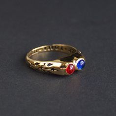 "Medieval ring with two gems and inscription \"Due tout mon coer\" (\"With all my heart\"). France or England, 15th century. Made after the artifact stored in the V&A Museum. Rings decorated with expressions of love - so called \"posy\" (from \"poesy\", poetry) rings often served as meaningful gifts to loved ones. At the same time, rings with paired gemstones were often used as engagement rings, two stones in one ring symbolized the alliance of two souls. So we can definitely say that this ring was a gift from within a loving couple. Brass cast, 24k gold plating, glass stones." Vintage Hand Forged Promise Rings, Antique Three Stone Gold Jewelry, Antique Gold Three-stone Jewelry, Heirloom Three Stone Birthstone Ring Gift, Vintage Promise Jewelry With Gemstone, Hand Forged Vintage Promise Jewelry, Vintage Gemstone Jewelry For Promise, Heirloom Three Stone Jewelry Gift, Spiritual Bezel Setting Promise Ring