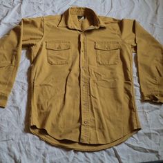 Vintage Deerskin Mustard Yellow Button-Front Long-Sleeve Utility Shirt Would best fit size L/XL Excellent condition Shirt With Buttoned Pockets For Fall, Fall Shirt With Solid Color And Buttoned Pockets, Solid Shirt With Buttoned Pockets For Fall, Solid Winter Shirt With Button Closure, Fall Khaki Shirt With Snap Buttons, Fall Long Sleeve Shirt With Buttoned Pockets, Khaki Shirt With Snap Buttons For Fall, Solid Winter Shirt With Buttons, Vintage Shirt With Casual Collar For Fall