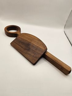 a wooden cutting board with a knife on it