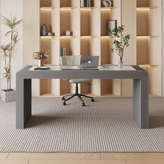 a desk with a laptop on it in front of a book shelf filled with books