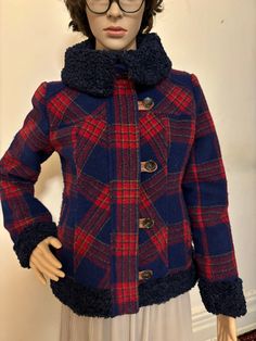 Elevate your winter wardrobe with this vintage Sundance wool plaid jacket featuring faux fur cuffs and collar. The mid-length jacket is made of wool flannel with a relaxed fit and features a zip and button closure. The multicolor plaid pattern adds a touch of  charm, perfect for travel, casual outings, or business meetings. Plaid Wool Outerwear For Cold Weather, Collared Plaid Winter Outerwear, Plaid Collared Outerwear For Winter, Plaid Wool Outerwear For Winter, Winter Wool Plaid Outerwear, Plaid Wool Coat For Winter, Winter Plaid Wool Outerwear, Cozy Fitted Outerwear With Button Closure, Fitted Wool Fur Coat For Winter