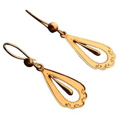 A pair of drop shaped Antique Swedish dangles in solid 18K Gold . A pair of European ca. 1920s -1930s earrings with drop shaped pendants and delicate hand- engraved ornaments. Freely suspended inner drop dangles are hollow inside. Hooks hallmarked 18K , all parts tested solid 18K Gold. Each earring is 40mm long suspended x 12 mm at widest. Weight: 2.1 grams pair. Condition is finest used, no repairs , all parts original. > Most of the items that we sell are not new at all if not stated otherwise