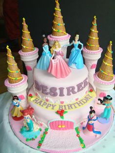 there is a birthday cake with princess figures on it