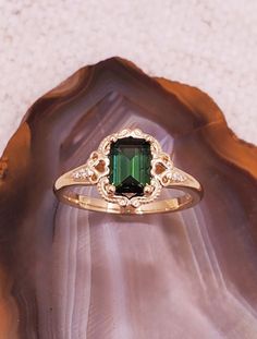 a green ring sitting on top of a shell