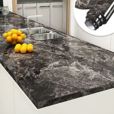 a kitchen with marble counter tops and stainless steel sink faucet in the center