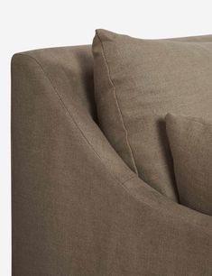 a close up view of the back of a couch with two pillows on top of it