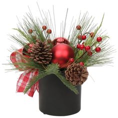 a christmas centerpiece with pine cones, berries and ornaments in a black vase on a white background