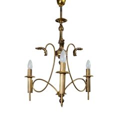 an antique brass chandelier with three lights on each arm and one light hanging from the ceiling