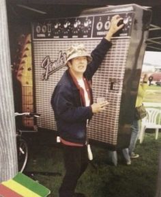 a man standing next to an old fashioned jukebox