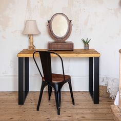 a wooden table with a mirror and chair in front of it on a hard wood floor