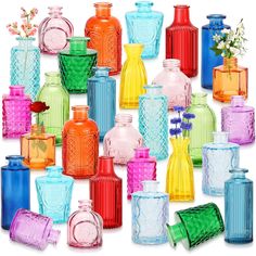 many different colored glass vases with flowers in the top and bottom one is empty