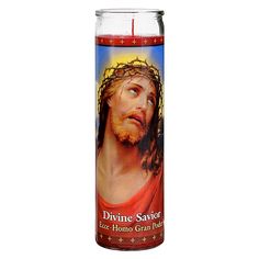 a candle with the face of jesus on it, in front of a white background