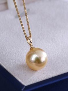 * Condition: Brand new * Center Stone: Natural Golden South Sea Pearl 9-10mm/10-11mm/11-12mm/12-13mm/13-14mm (options) * Pearl Shape Grade: Perfectly Round * Metal Purity: 18K Solid Yellow Gold * Chain Length: 45cm * Superior pearls standard - 99% of the pearl surface is clean. An extremely detailed and up-close study of the pearl is needed to find imperfections. * The item will be gift wrapped and shipped. ------------------AUTHENTICITY------------------ Authenticity is the backbone of our busi Classic Yellow Necklace With Round Pendant, Classic Yellow Round Pendant Necklace, Elegant 14k Gold Yellow Necklace, Elegant Yellow 14k Gold Necklace, Classic Gold Necklaces With High Luster, Classic Gold Necklace With High Luster, Elegant Yellow Necklace With High Luster, Elegant Yellow Jewelry With Round Beads, Elegant Yellow Round Bead Necklaces