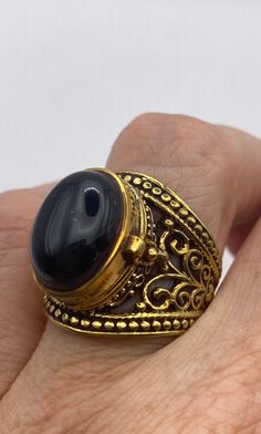 Vintage Black Onyx Brass Poison Pillbox Ring Unique Antique Finish Rings As Gift, Black Spiritual Jewelry With Antique Finish, Antique Finish Ring Jewelry Gift, Antique Finish Jewelry Ring As A Gift, Antique Finish Ring Jewelry For Gift, Vintage Gold Ring With Large Stone, Vintage Gold Rings With Large Stone, Black Brass Rings For Gift, Ornate Gold Cabochon Rings