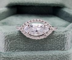 an oval shaped diamond ring with two rows of diamonds around it