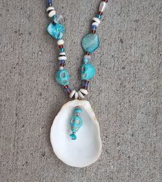 This is a blue & turquoise color beaded necklace, made with shells, pearl, acrylic, and glass beads.  The skulls on the necklace are made out of stone.  Inspired by spiritual ceremonies the holistic effects of this necklace provides protection from outside sources, along with balancing and aligning all chakras, stabilizing mood, and instilling an inner calm.  Necklace Measurements:  Length: 24" Pendant Height: 2.5" Pendant Width: 2" If you have any questions or would like to see additional pictu Turquoise Necklace With Large Beads For Beach, Blue Festival Jewelry Ocean-inspired, Blue Ocean-inspired Jewelry For Festivals, Blue Ocean-inspired Festival Jewelry, Turquoise Shell Beaded Necklaces, Turquoise Shell Beaded Necklaces With Round Beads, Bohemian Shell With Colorful Beads For Gift, Turquoise Shell Round Bead Jewelry, Turquoise Beaded Shell Jewelry