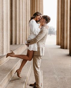 a man and woman kissing in front of the lincoln memorial with their legs spread out