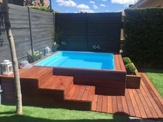 an above ground pool surrounded by wooden steps