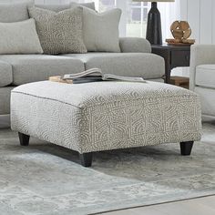 a living room scene with focus on the ottoman