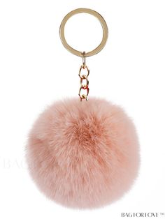 a pink pom - pom keychain hanging from a metal ring on a white background