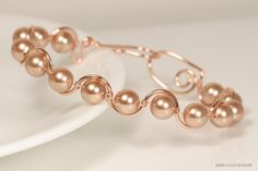 Rose Gold Pearl Bracelet Handmade by Jessica Luu Jewelry ~ Elegant ~ Sophisticated ~ Feminine ~ From brunch to cocktail parties, this hand crafted bracelet is the perfect accompaniment to every occasion. MATCHING ITEMS https://www.etsy.com/shop/JessicaLuuJewelry?search_query=Rose+gold+pearl+rg BRACELET DETAILS: ~ 8mm rose gold Swarovski pearls ~ 14 karat rose gold filled wire ~ 14 karat rose gold filled hook and eye clasp This bracelet is 7.5 inches around. Because it is made with very thick 14k Wire Jewelry Ideas, Earrings Handmade Tutorial, Rose Gold Beaded Bracelet, Cocktail Bracelet, Handmade Tutorial, Bridal Bracelet Pearl, Gold Pearl Bracelet, Swarovski Crystal Rings, Rose Gold Pearl