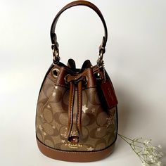 New With Tag! Coach Mini Dempsey Bucket Bag In Signature Jacquard Brand New With Tags Limited Edition Signature. Jacquard And Refined Pebble Leather One Credit Card Slot Drawstring Closure, Fabric Lining Detachable Handle With 5 1/2" Drop Detachable Strap With 23" Drop For Shoulder Or Crossbody Wear 5 1/2" (L) X 6 1/2" (H) X 3 1/2" (W) This Coach Piece Is Crafted Of Our Signature Jacquard Made From A Blend Of Organic Cotton And Recycled Polyester. Hobo Crossbody Bag, Coach Crossbody Bag, Crossbody Wallet, Black Leather Bags, Coach Leather, Leather Crossbody Purse, Leather Messenger, Small Crossbody Bag, Shoulder Purse