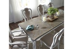 a dining room table with chairs around it