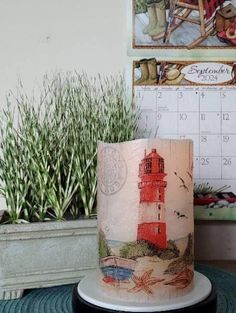 a cake sitting on top of a table next to a potted plant and calendar