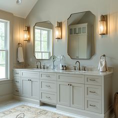 a large bathroom with double sinks and mirrors