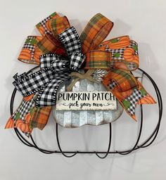 a pumpkin patch is hanging on a wire rack with a sign that says pumpkin patch pick your own